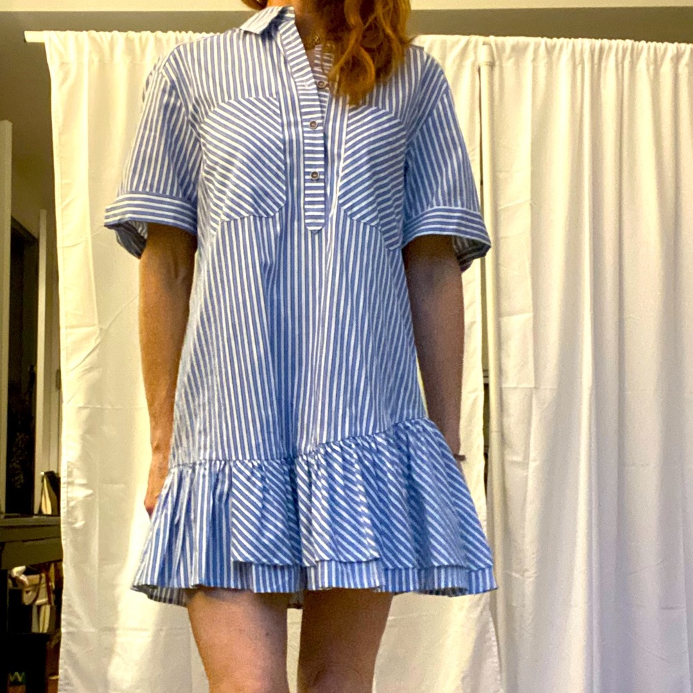 Pinstripe dress with front pocket and asymmetrical drop-hem bottom ruffle